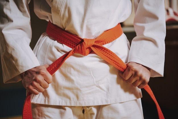 Close up red belt on white keikogi of martial arts fighter. | Premium Photo