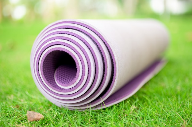 Free Photo | Close-up of rolled exercise mat on grass