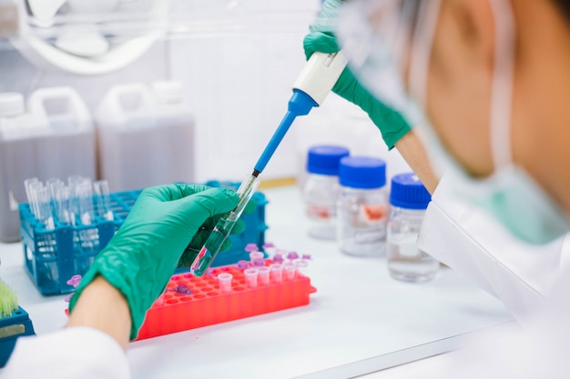 Premium Photo | Close up scientist using pipette transfer sample to ...