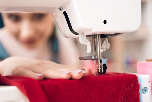 Premium Photo | Close up sewing machine makes a new dress.