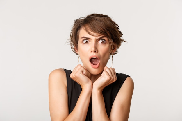 Premium Photo | Close-up of shocked and startled young woman looking ...