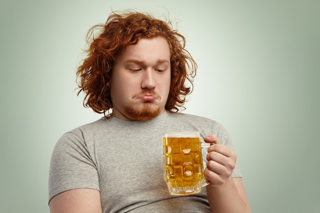 Free Photo | Close up shot of indecisive male with ginger hair holding ...