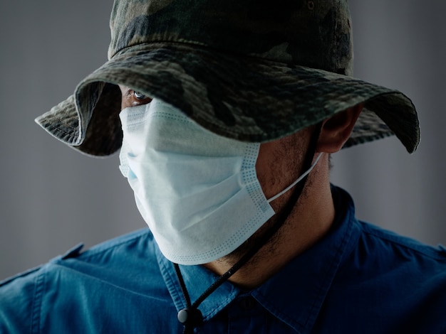 Download Premium Photo Close Up Shot Man In Medical Mask And Camouflage Bucket Hat Military Style Panama Hat