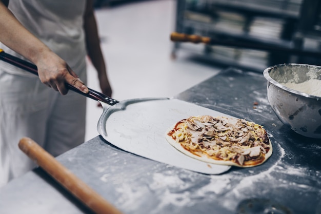 Premium Photo | Close up shot of pizza making or preparing process.