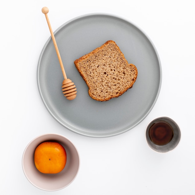 Close-up slice of bread on plate with honey Free Photo