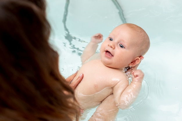 Close-up smiley baby in the bathtub Free Photo