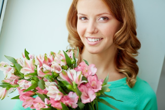 Free Photo | Close-up of smiling woman holding a bouquet