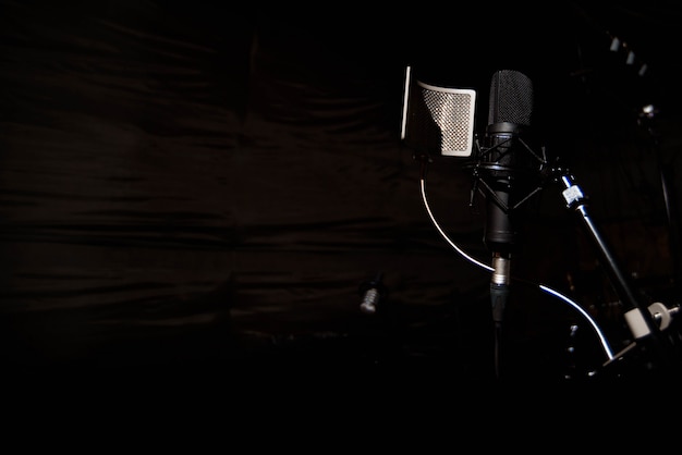 Close up studio condenser microphone with pop filter Premium Photo