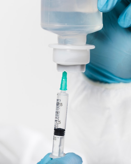 Close-up syringe with medical treatment Free Photo