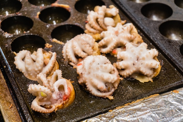 Premium Photo | Close up of takoyaki with squid, making takoyaki by big