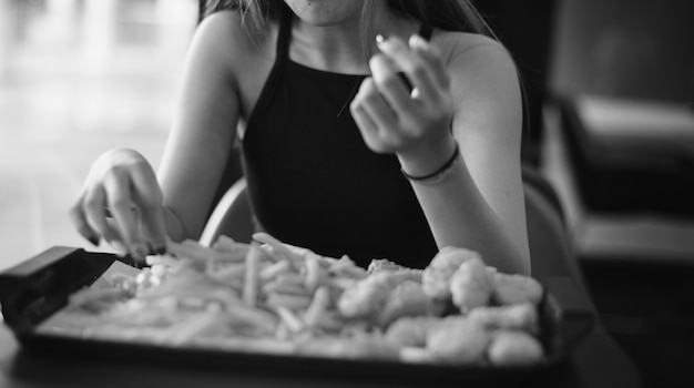 Close up of teenage girl eating french fries obesity concept Free Photo