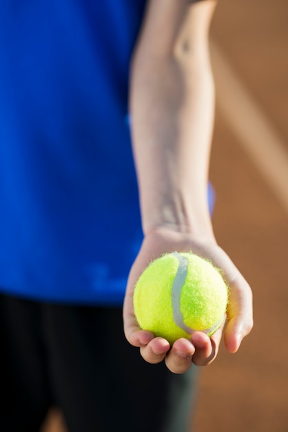 Free Photo | Close-up tennis ball held in hand