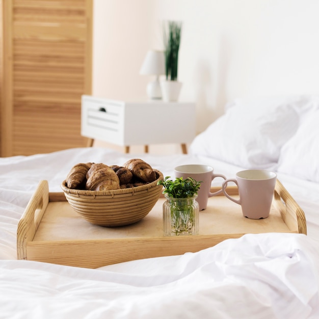 Close-up tray with breakfast on bed Free Photo