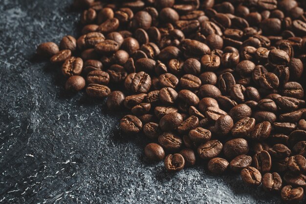 Free Photo | Close up view of brown coffee seeds on dark