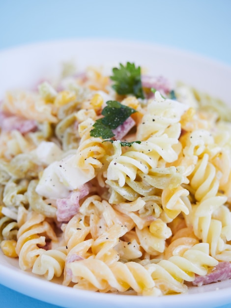 Premium Photo | Close up view pasta salad with corn, cheese and ham ...