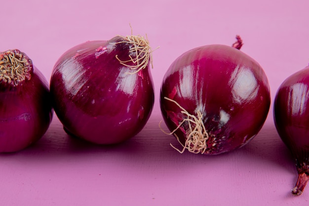 Free Photo | Close-up View Of Red Onions On Purple Background With Copy ...