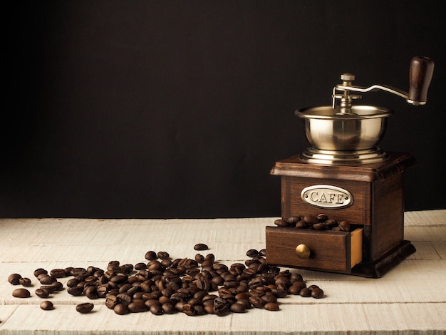 Premium Photo | Close-up vintage coffee grinder mill with coffee grains ...