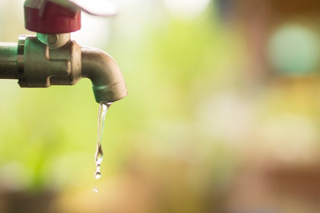 Premium Photo | Close up water drop from tab, leaking water