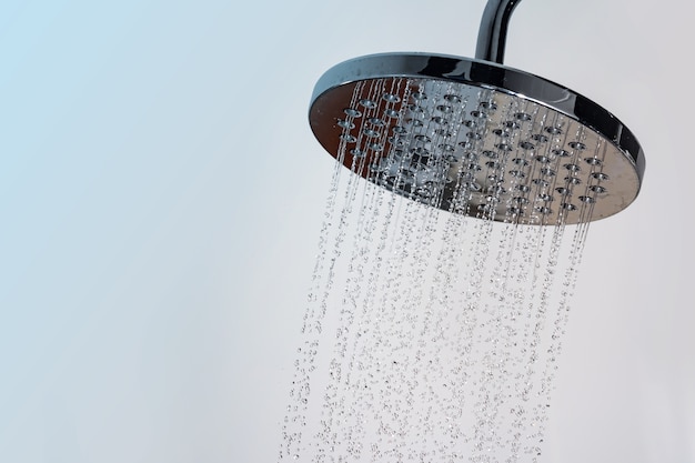 Close Up Of Water Flowing From Shower In The Bathroom Photo