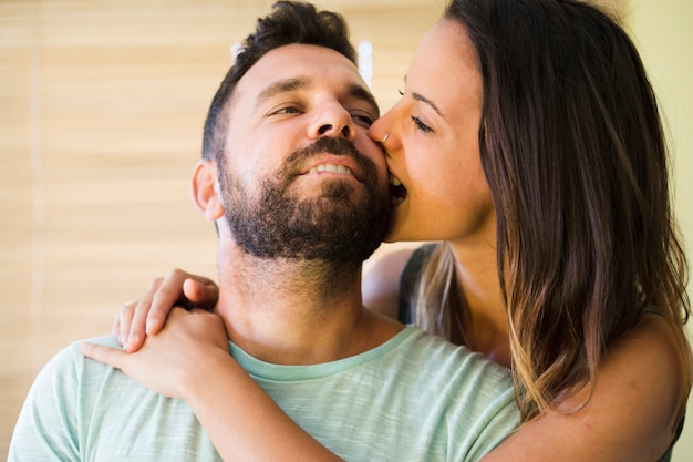 Free Photo Close Up Of A Woman Biting Her Husband Cheek 