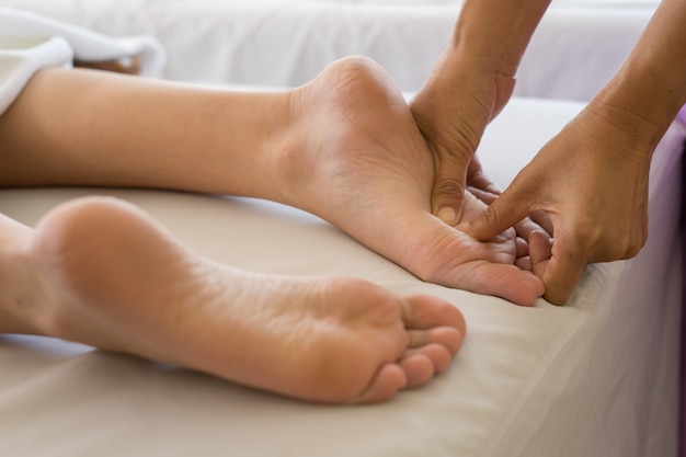 Close-up of woman doing foot massage at spa. Free Photo