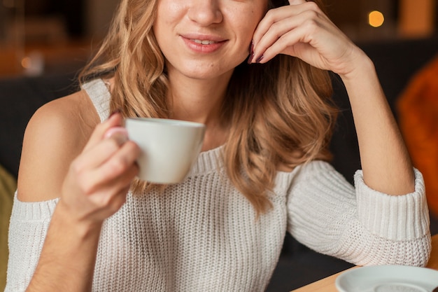 Close-up woman drinking cup of coffee | Free Photo