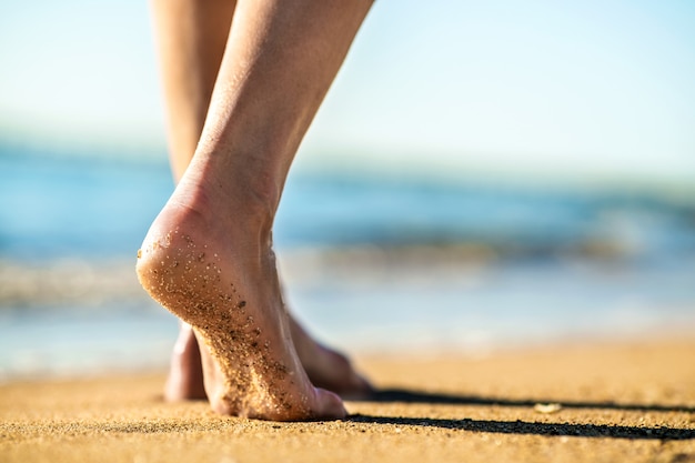 Premium Photo Close Up Of Woman Feet Walking Barefoot On Sand Leaving Footprints On Golden