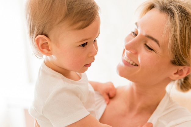 Free Photo | Close-up woman holding baby and smiling