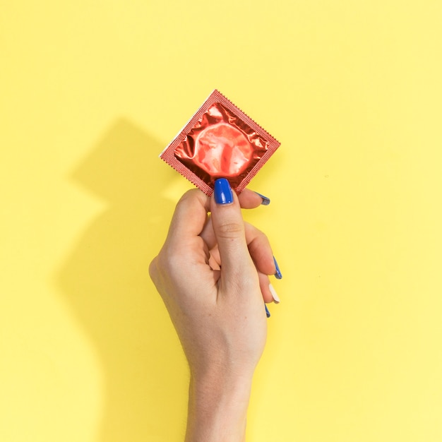 Premium Photo Close Up Woman Holding Up A Condom 