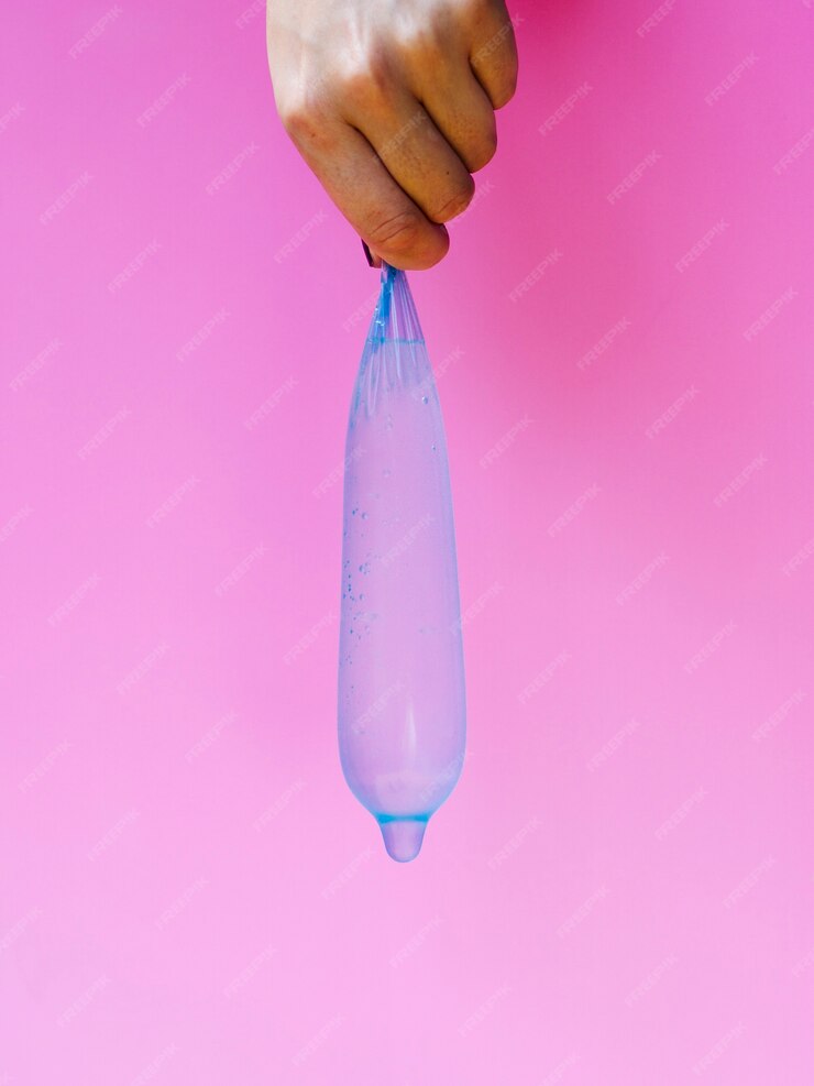 Free Photo | Close-up woman holding up a filled condom