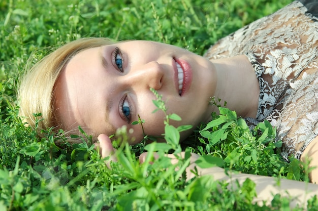 Premium Photo Close Up On Woman Laying On Grass Smiling