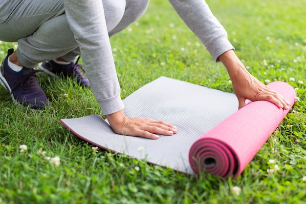 Close Up Woman Preparing Yoga Mat Photo Free Download