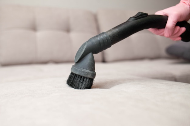 Premium Photo | Close up of woman's hand cleaning couch using vacuum ...