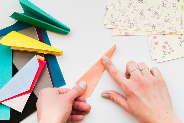 Free Photo | Close-up of woman's hand making paper airplane with ...