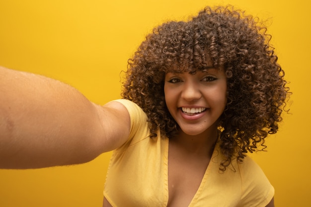 Close Up Of Woman With Afro Hairstyle And Yellow Top Photo