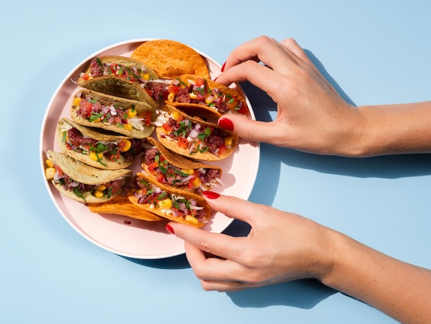 Free Photo | Close-up woman with plate full of tacos