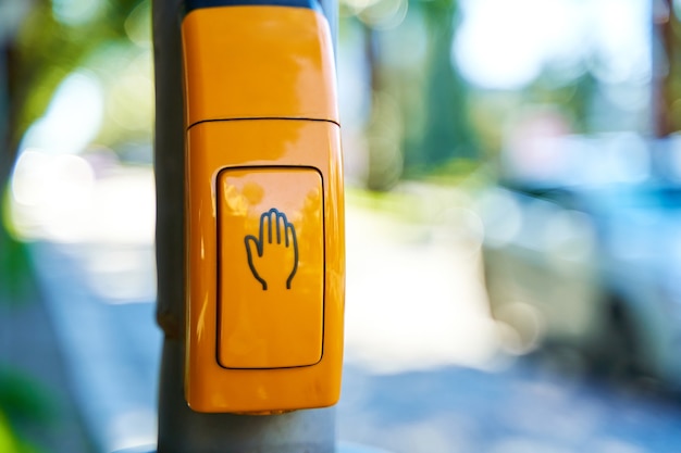 Premium Photo | Close-up, yellow button to switch traffic lights.