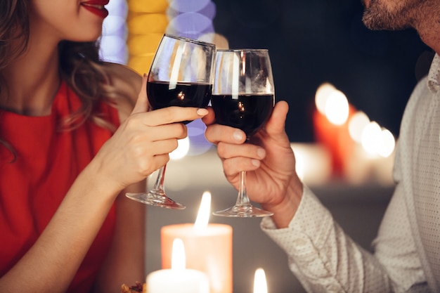 Close up of young couple holding glasses with wine | Free ...