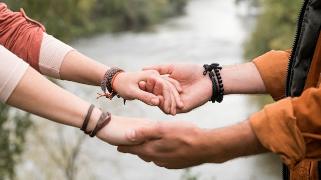 Free Photo Close Up Young Couple Holding Hands Near River