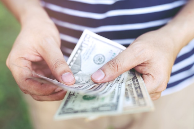 Premium Photo | Close up young man standing hand hold count the money ...