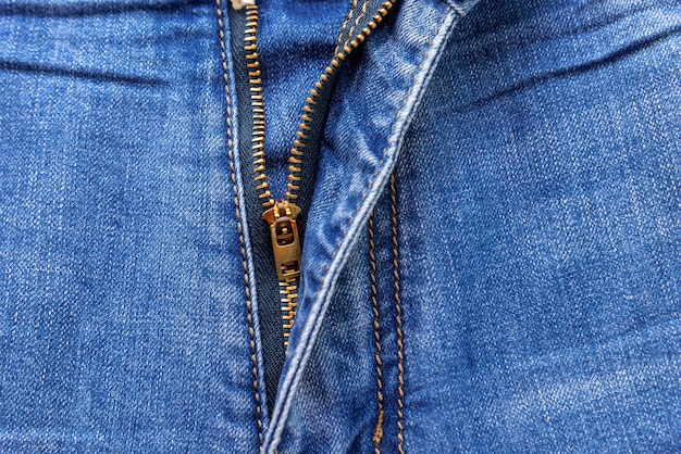 Premium Photo | Close up of a zipper half unzipped on a of blue jeans ...