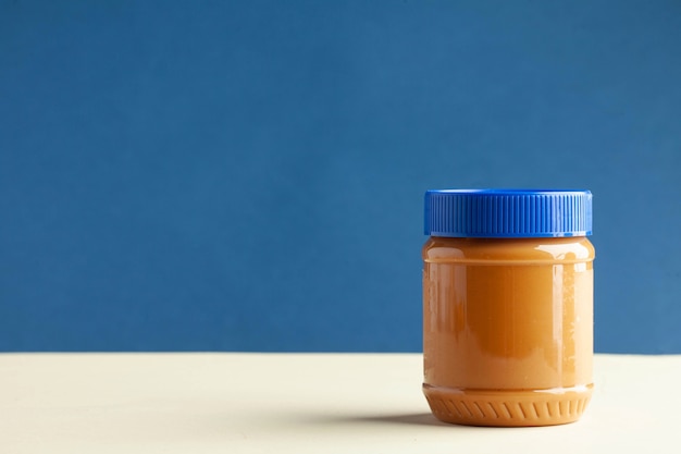 Premium Photo | Closed can of peanut butter on a colored background ...