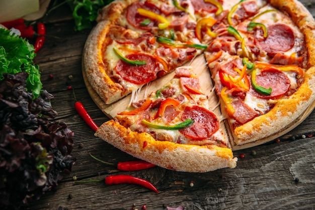 Closeup on appetizing hot pizza pepperoni with salami Premium Photo