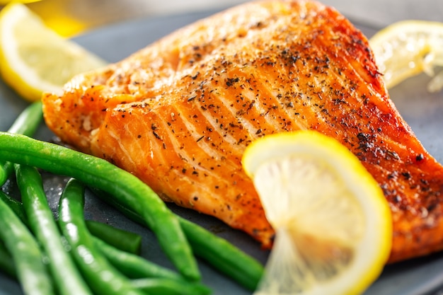 Closeup of baked salmon fish with green beans Photo | Free Download