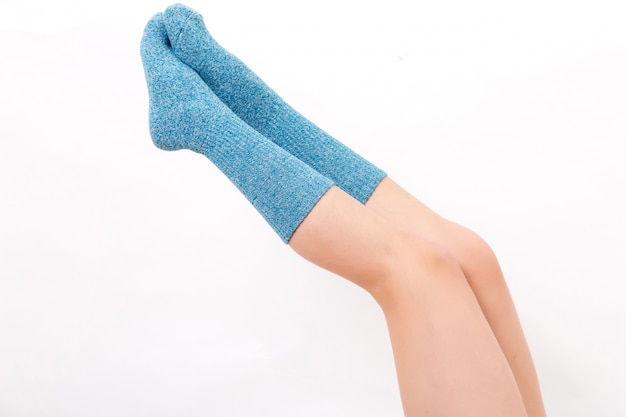 Closeup Of The Bare Legs Of A Young Woman Wearing Blue Socks With