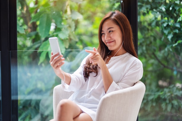 Premium Photo | Closeup of a beautiful asian woman using mobile phone for video  call at home