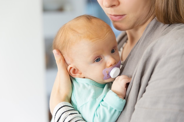 Free Photo Closeup Of Cute Adorable Red Haired Baby With Soother