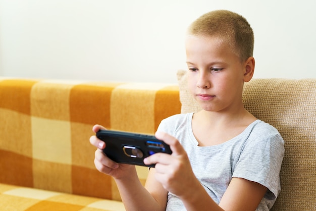 Premium Photo | Closeup of cute little boy using smartphone looking at ...