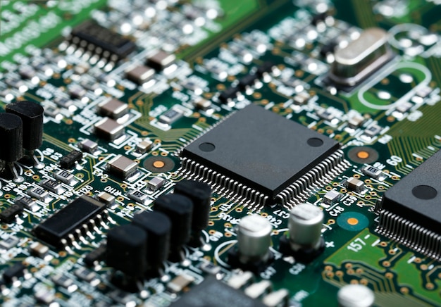 Closeup of electronic circuit board with cpu microchip electronic components background Free Photo