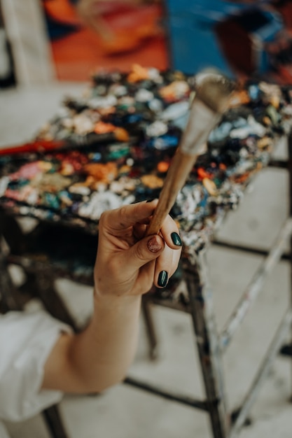 Premium Photo Closeup Of Female Artist Hand Holding Paintbrush At Art